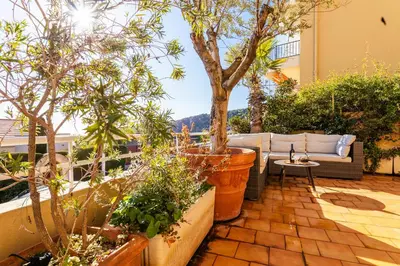 a patio with a couch and some plants and a tree at HENRIETTA AP4070 - avenue Soleil d'Or - Villefranche-sur-Mer in Villefranche-sur-Mer