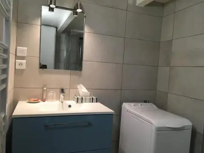 a bathroom with a sink and a washing machine at Heart of Nice Harboor cosy and central in Nice
