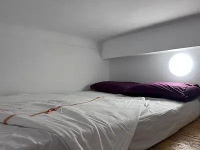 a white bed with purple pillows in a room at Heart of Nice Harboor cosy and central in Nice
