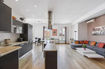 a kitchen and living room with a couch and a table at Le Blacas in Nice