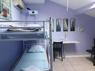 a room with two bunk beds and a desk at Antares hostel in Nice