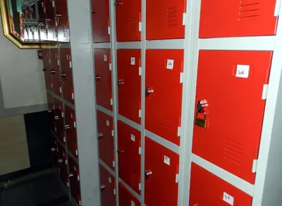 a row of lockers in a room with red doors at Antares hostel in Nice