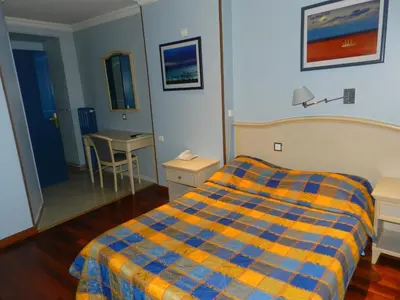 a hotel room with a bed and a desk at Antares hostel in Nice