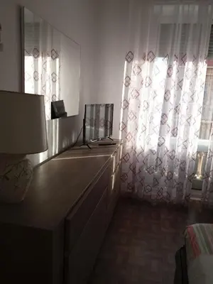 a bedroom with a dresser and a window with curtains at Nice Centre, Charmant Studio in Nice