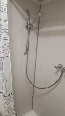 a shower with a hose in a bathroom at Nice Centre, Charmant Studio in Nice