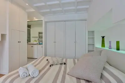 a bedroom with a bed with two towels on it at MY CASA - LIBERTÉ - Spacious Apartment City Center w AC in Nice