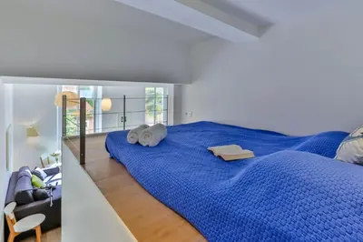 a bedroom with a blue bed with two towels on it at MY CASA - LIBERTÉ - Spacious Apartment City Center w AC in Nice