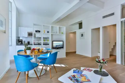 a kitchen and living room with a table and chairs at MY CASA - LIBERTÉ - Spacious Apartment City Center w AC in Nice