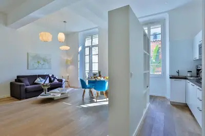 a living room with a couch and a table at MY CASA - LIBERTÉ - Spacious Apartment City Center w AC in Nice