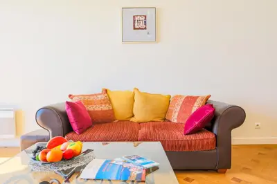 a living room with a couch with colorful pillows at LE FLORIDE AP4156 Nice, by Riviera Holiday Homes in Nice