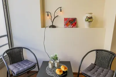 two chairs and a table with a plate of fruit on it at LE FLORIDE AP4156 Nice, by Riviera Holiday Homes in Nice