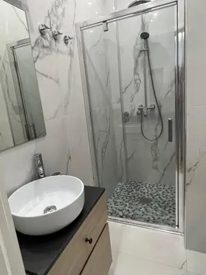 a bathroom with a shower with a sink and a toilet at D’AZUR-35 in Nice