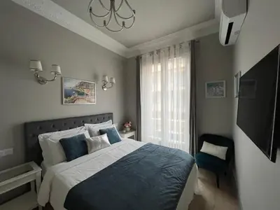 a bedroom with a large bed and a window at D’AZUR-35 in Nice