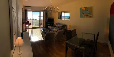 a living room with a couch and a table at **** Panoramic Top Roof in Beaulieu **** in Beaulieu-sur-Mer