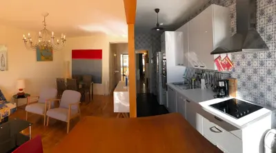 a kitchen with white cabinets and a dining room at **** Panoramic Top Roof in Beaulieu **** in Beaulieu-sur-Mer