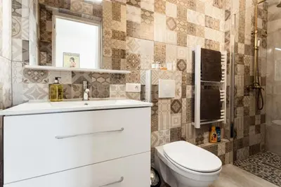 a bathroom with a toilet and a sink at Chic appartement Centre NICE au calme vue colline in Nice
