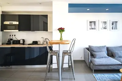 a kitchen with a table and two chairs in a room at La Maioneta Carré d'Or in Nice