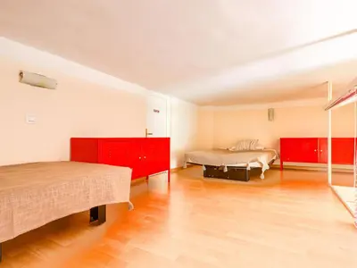 a bedroom with two beds and red cabinets at Apartment Le Masséna by Interhome in Nice