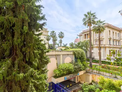 a view of a building and a palm tree at Apartment Le Masséna by Interhome in Nice