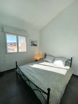 a bed in a bedroom with a window at TOBIAS - Appartement Duplex 4 personnes Quartier Riquier Nice in Nice