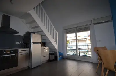 a kitchen with a white refrigerator and a staircase at TOBIAS - Appartement Duplex 4 personnes Quartier Riquier Nice in Nice