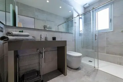 a bathroom with a toilet and a glass shower at Nice Jean Médecin in Nice