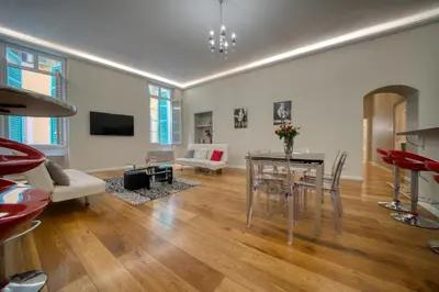a living room with a table and chairs and a couch at Old Town Luxury 3 Beds in Nice