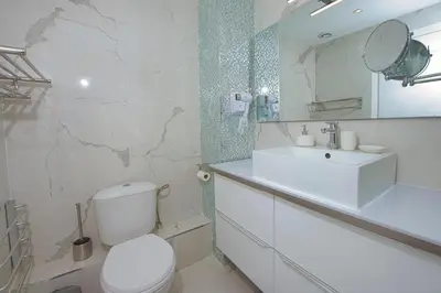 a white bathroom with a toilet and a sink at BEACH FLAT in Nice