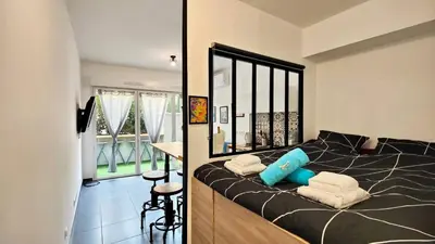 two pictures of a bedroom with a bed in a room at Alex Nice Studio in Nice