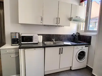 a white kitchen with a sink and a microwave at Nestor&Jeeves - RED TOUCH - Central - Close sea in Nice