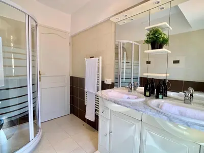 a bathroom with two sinks and a large mirror at Palais Massena - Easy Home Booking in Nice