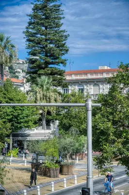 a group of people riding bikes on a city street at Prestige Designer Apartment, Super Central in Nice