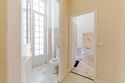 a bathroom with a toilet and a tub and a window at Prestige Designer Apartment, Super Central in Nice