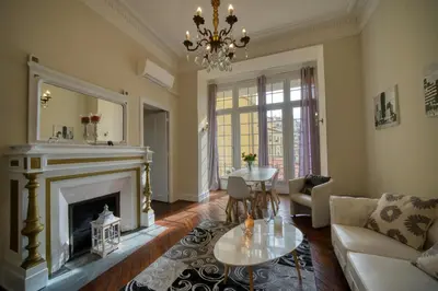 a living room with a fireplace and a chandelier at Prestige Designer Apartment, Super Central in Nice