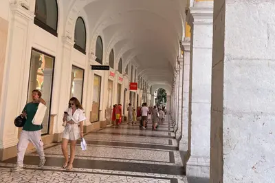 a group of people walking down a hallway in a building at Cosy Cocoon Place Massena in Nice