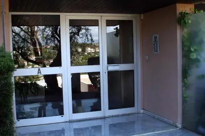 a sliding glass door of a house with windows at Studio Le Fabrina Riviera in Nice