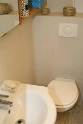 a bathroom with a white toilet and a sink at Studio Le Fabrina Riviera in Nice