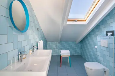 a bathroom with a sink and a mirror and a toilet at Hostel Ozz Nice in Nice