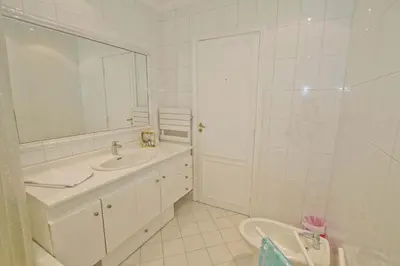 a white bathroom with a sink and a mirror at PROMENADE HOLIDAY - CARIATIDE PROMENADE SEA VIEW in Nice
