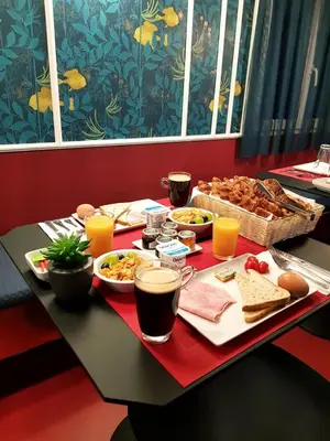 a table topped with a tray of food and drinks at Hôtel les Cigales in Nice
