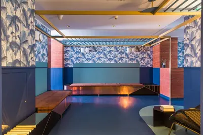 a waiting room with benches and blue walls at Hôtel les Cigales in Nice
