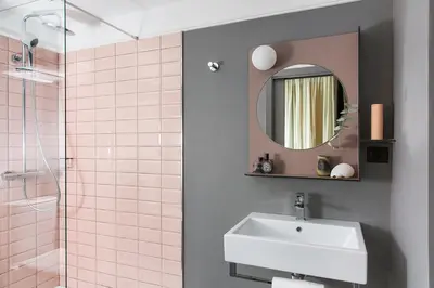 a bathroom with a sink and a mirror and a shower at Hôtel les Cigales in Nice