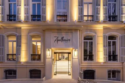 a building with the entrance to a store at Hôtel Apollinaire Nice in Nice
