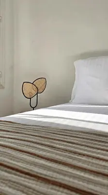 a bedroom with a bed with a headboard and ainylinylinylinylinyl at Hôtel de la Fontaine in Nice