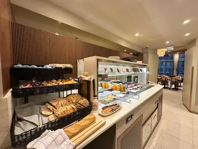 a bakery counter with a lot of bread and pastries at Hotel Ambassador, completely renovated in Nice