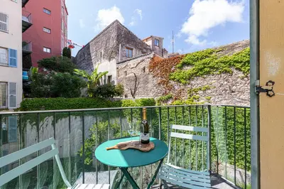 a table and two chairs on a balcony at 2 Bdrs & Parking in the Old Town ! in Nice