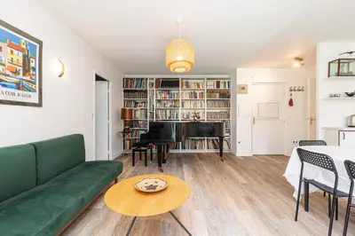 a living room with a green couch and a piano at 2 Bdrs & Parking in the Old Town ! in Nice