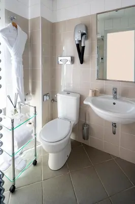 a bathroom with a toilet and a sink at Hotel Suisse in Nice