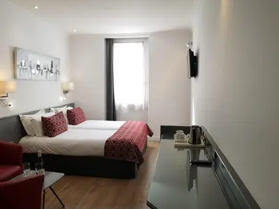a hotel room with a bed and a window at Hotel Boréal Nice in Nice