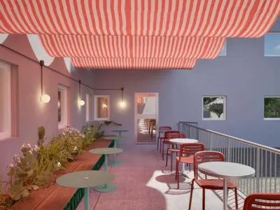 a restaurant with tables and chairs under a red umbrella at Greet Hotel Nice Aéroport Promenade des Anglais in Nice